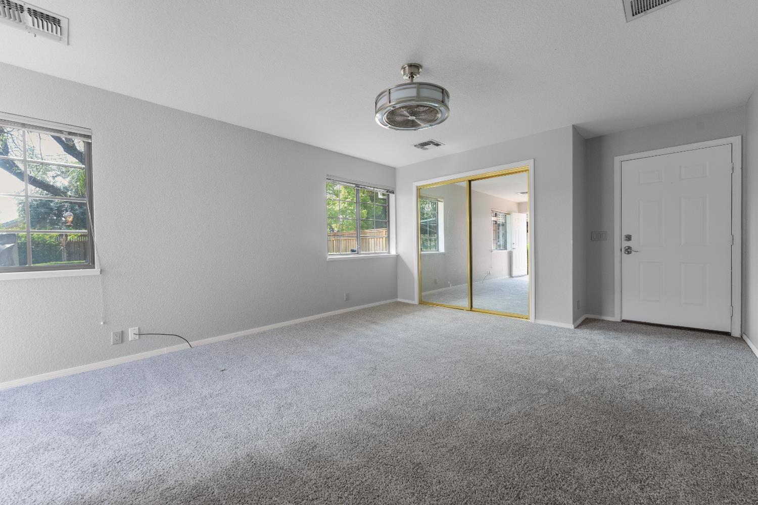 1801 Arroyo Drive Auburn, CA 95603 - Photo 43 of 68 a view of a big room with windows and chandelier fan