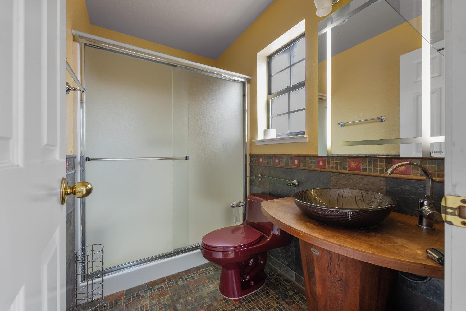 1801 Arroyo Drive Auburn, CA 95603 - Photo 45 of 68 a bathroom with a sink a toilet and a mirror