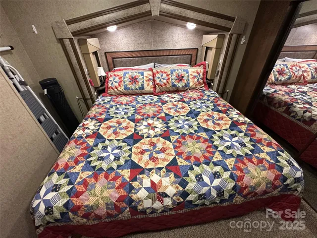 a bed sitting in a bedroom next to a window