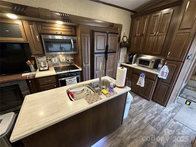 a kitchen with a stove and a refrigerator