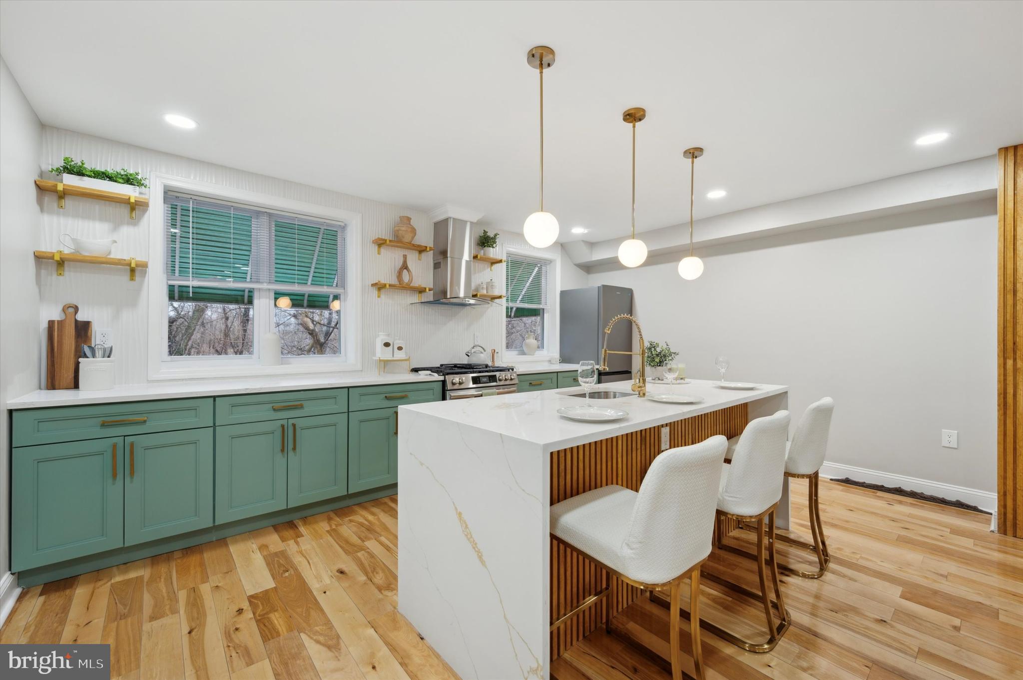a kitchen with a dining table chairs and white cabinets
