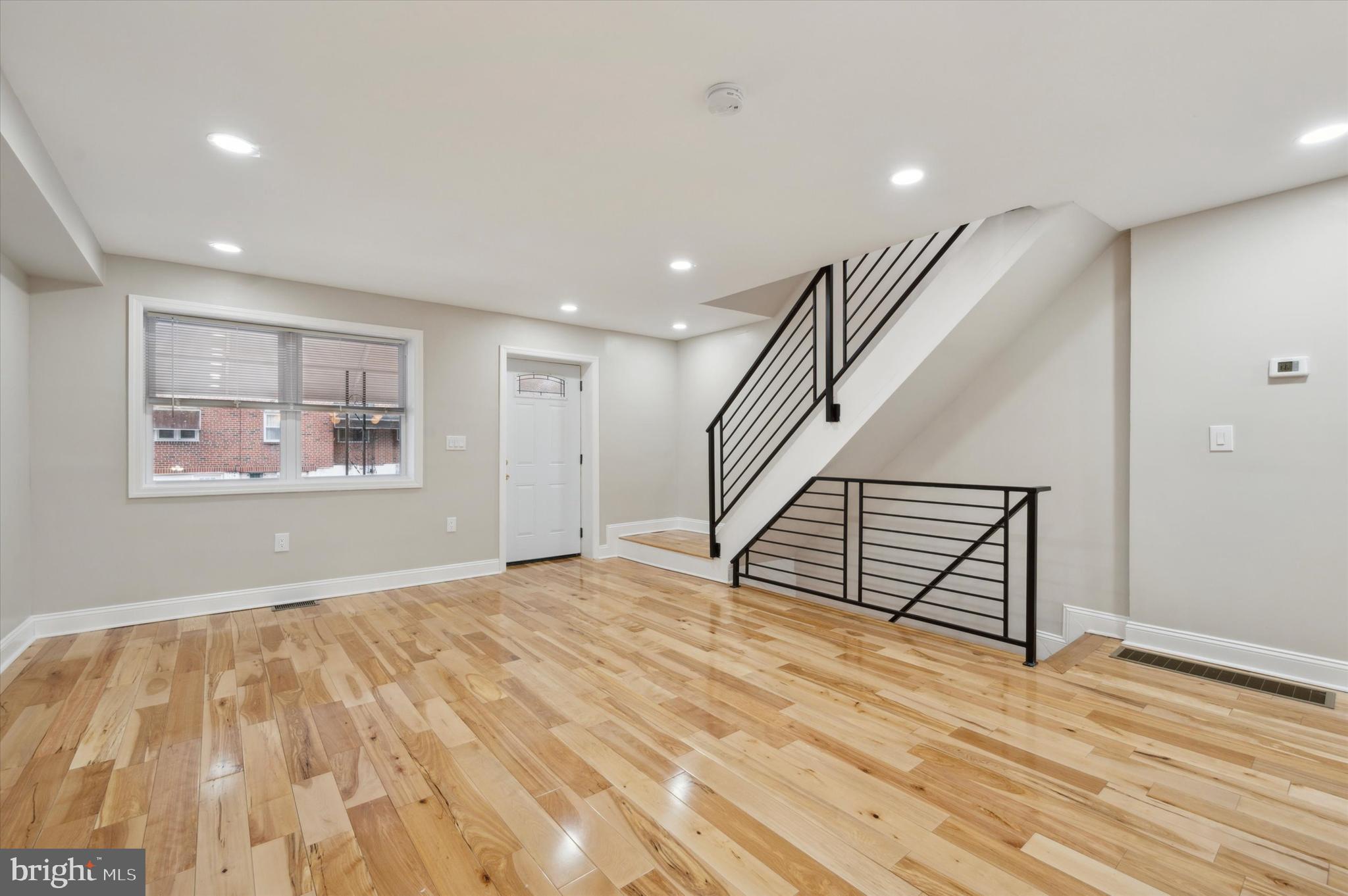 7533 Wheeler Street Philadelphia, PA 19153 - Photo 11 of 50 a view of an empty room with wooden floor and stairs