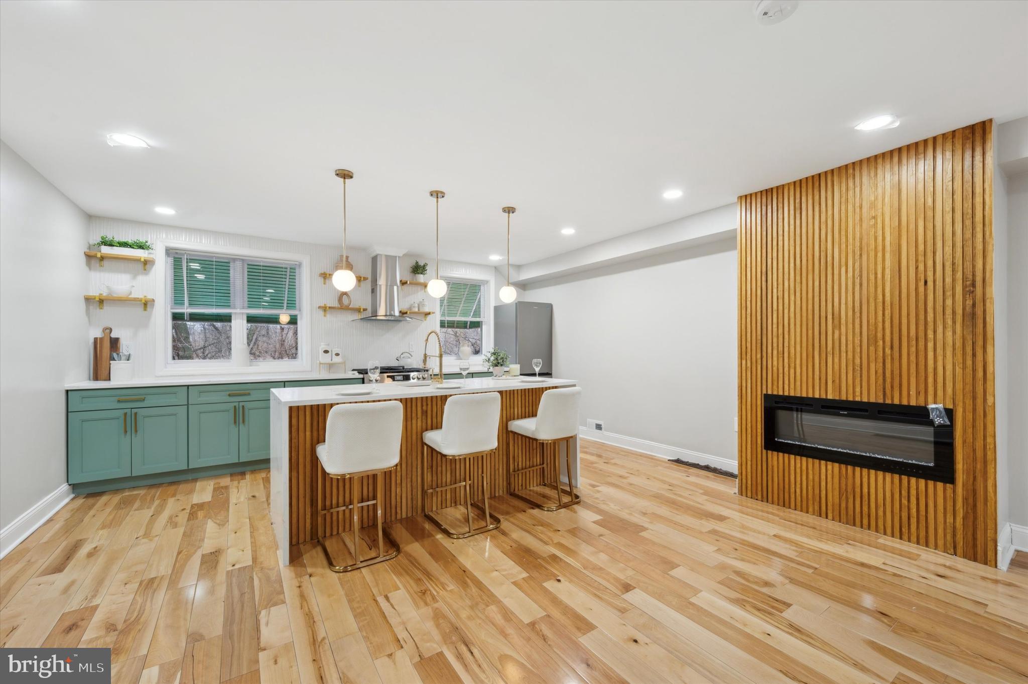 7533 Wheeler Street Philadelphia, PA 19153 - Photo 13 of 50 a kitchen with a sink cabinets and wooden floor