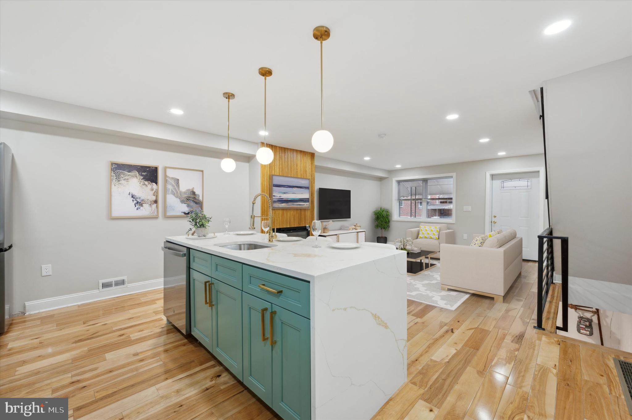 7533 Wheeler Street Philadelphia, PA 19153 - Photo 15 of 50 a view of kitchen with kitchen island stainless steel appliances sink stove and wooden floor