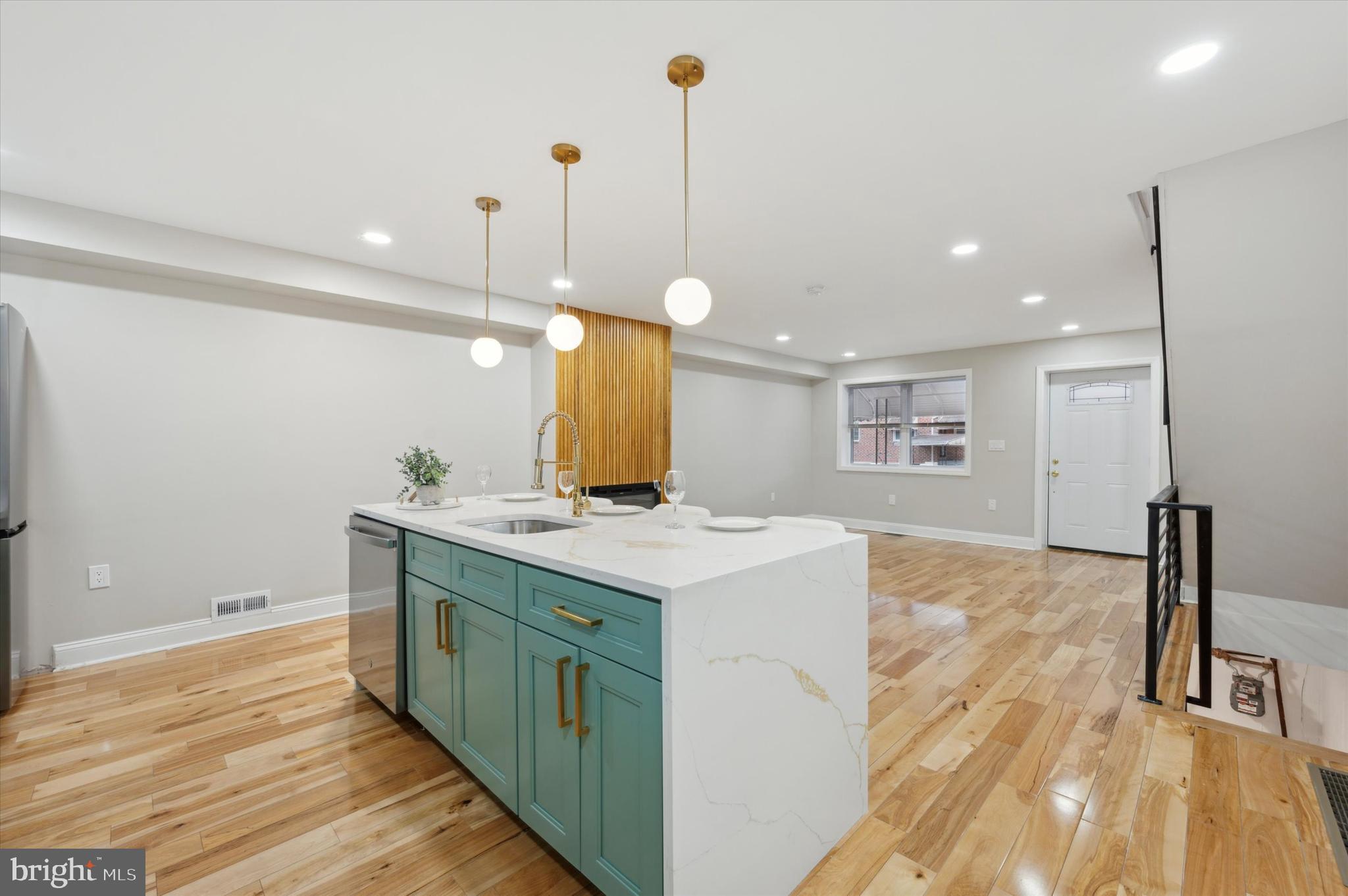 7533 Wheeler Street Philadelphia, PA 19153 - Photo 16 of 50 a kitchen with kitchen island a sink appliances and wooden floor