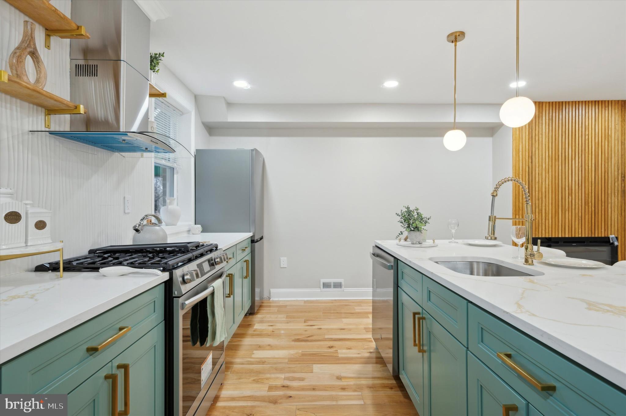 7533 Wheeler Street Philadelphia, PA 19153 - Photo 17 of 50 a kitchen with a sink stove and cabinets