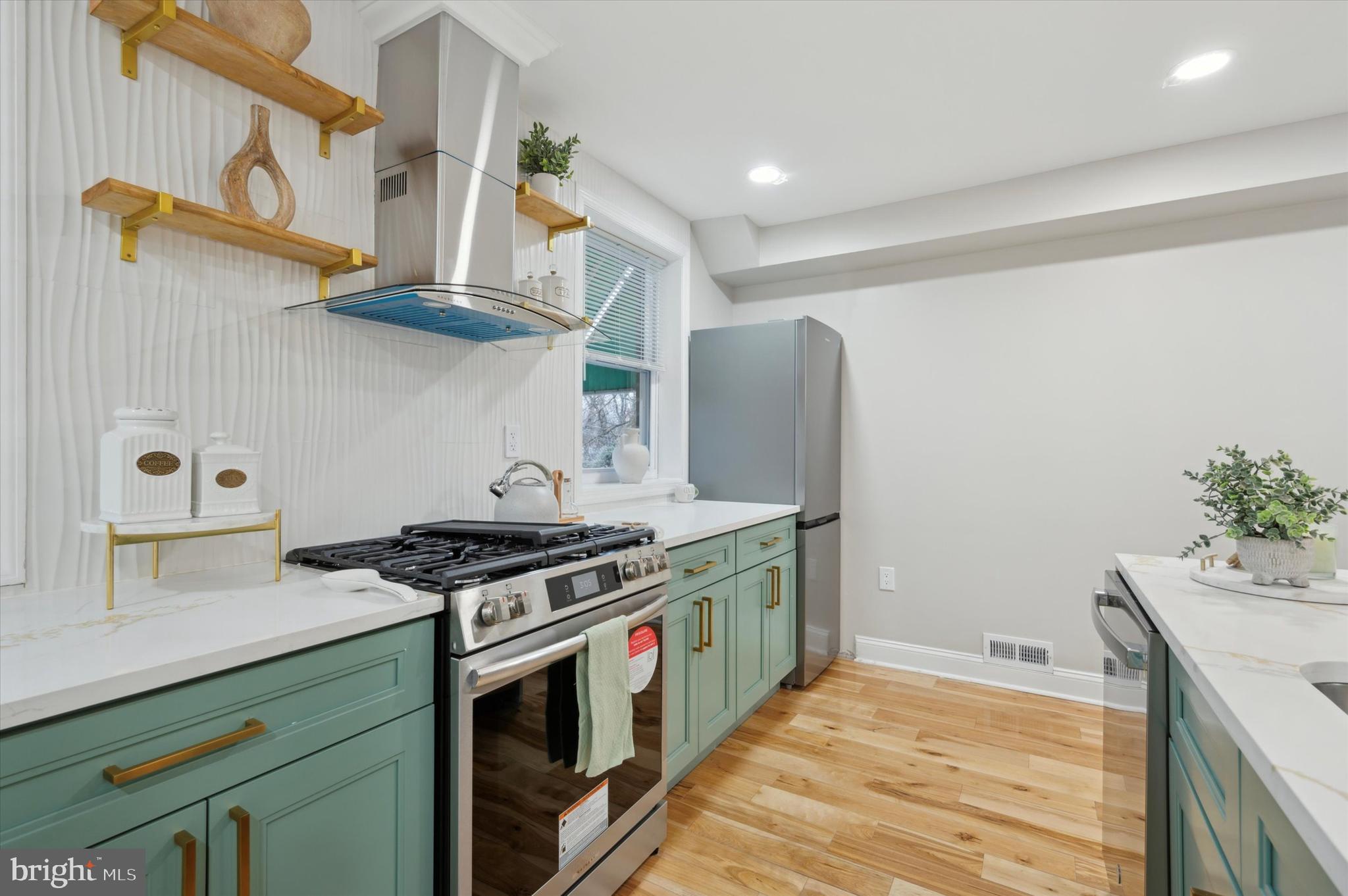 7533 Wheeler Street Philadelphia, PA 19153 - Photo 18 of 50 a kitchen with stainless steel appliances granite countertop a stove and a sink