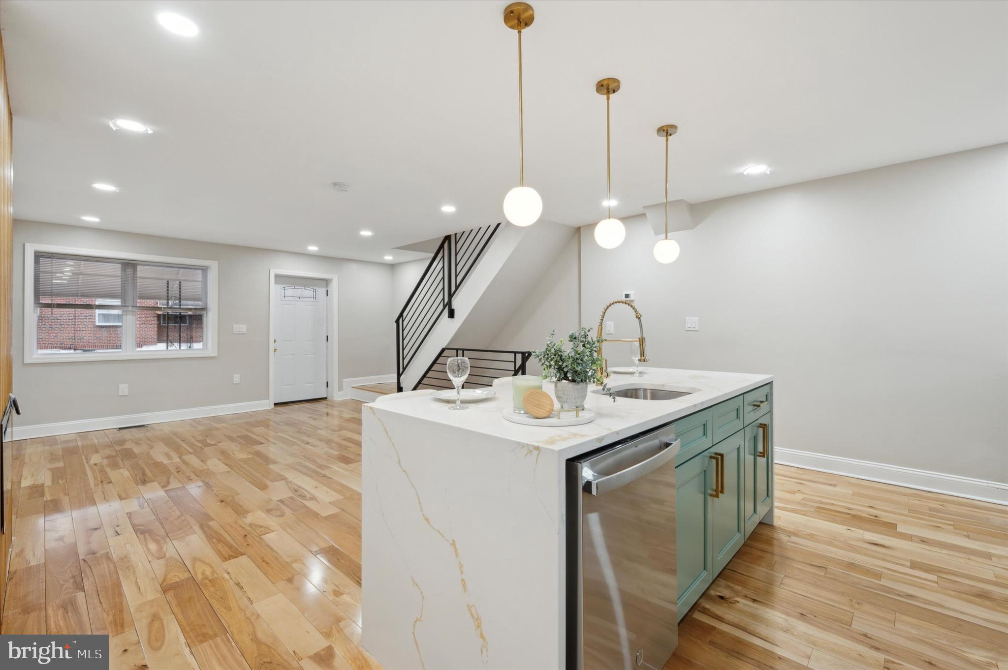 7533 Wheeler Street Philadelphia, PA 19153 - Photo 20 of 50 a kitchen with a sink a chandelier and wooden floor
