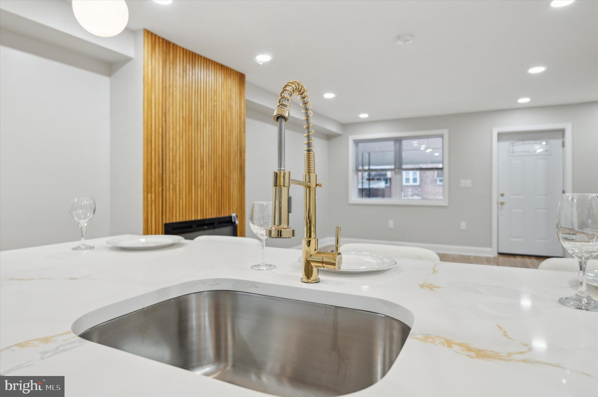 7533 Wheeler Street Philadelphia, PA 19153 - Photo 21 of 50 a bathroom with a sink a faucet and a mirror