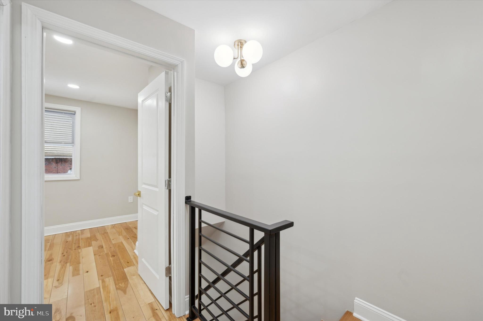 7533 Wheeler Street Philadelphia, PA 19153 - Photo 23 of 50 a view of a hallway with wooden floor and a chandelier