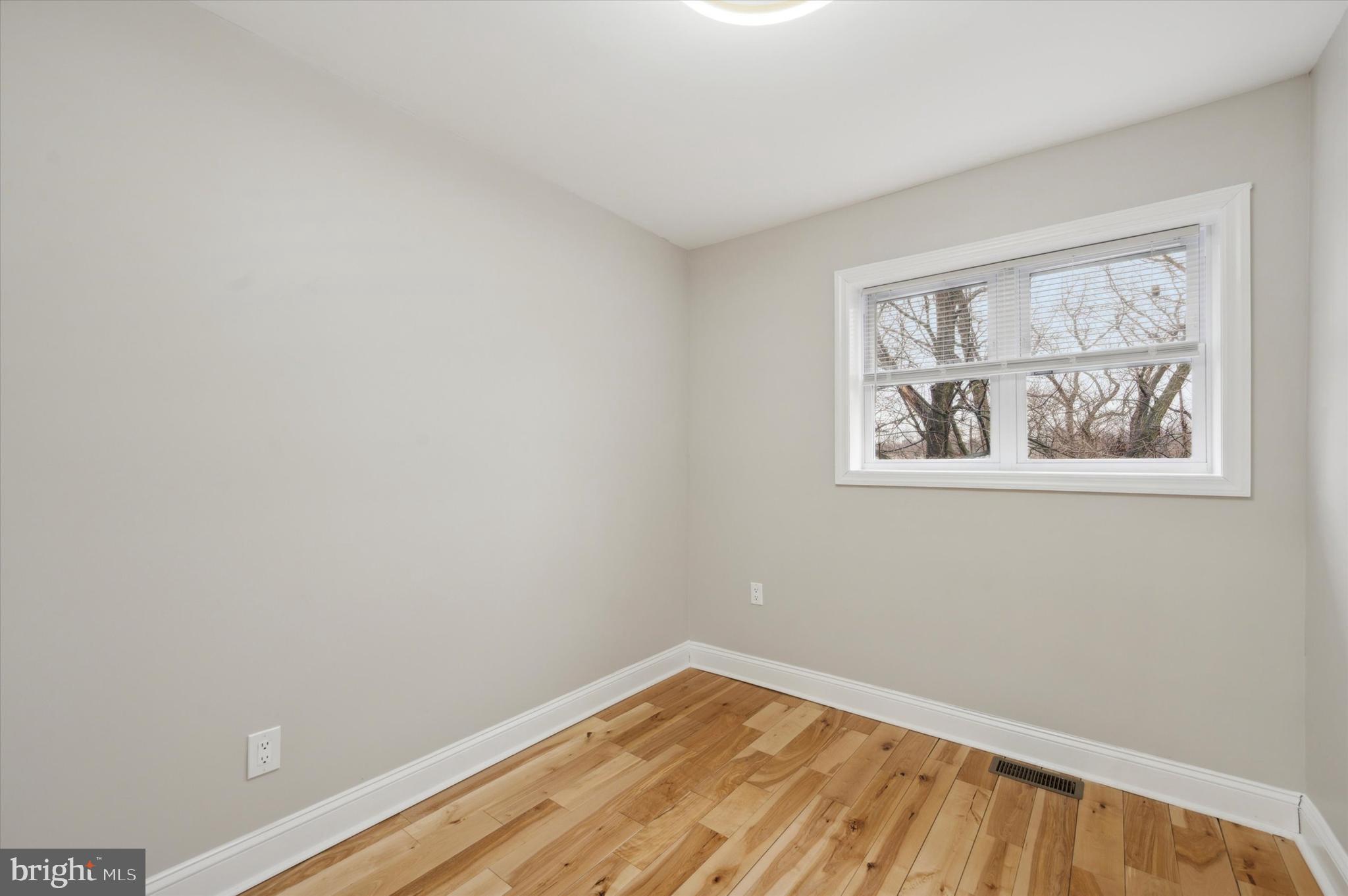 7533 Wheeler Street Philadelphia, PA 19153 - Photo 25 of 50 a view of an empty room with wooden floor and a window