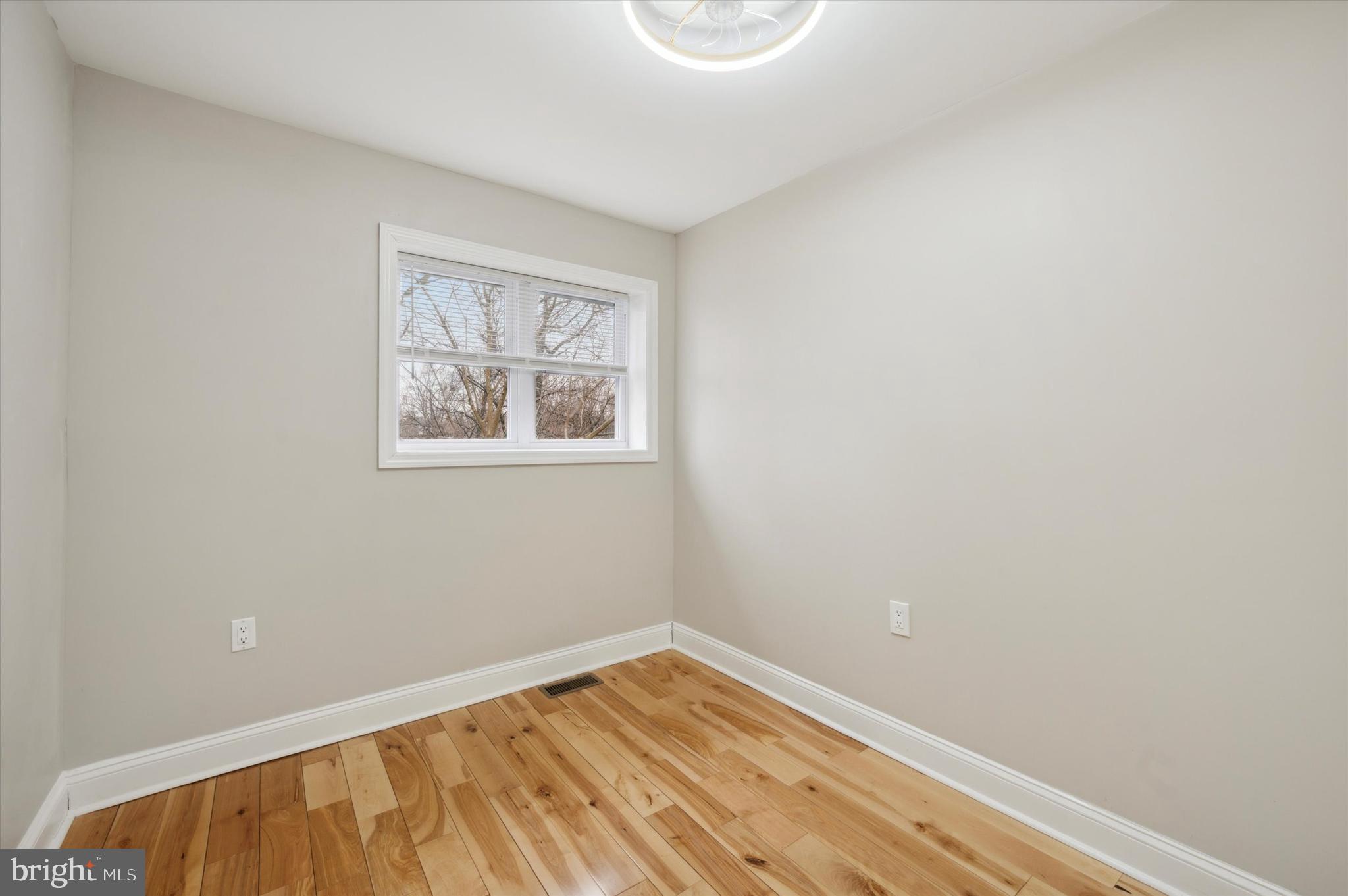 7533 Wheeler Street Philadelphia, PA 19153 - Photo 27 of 50 a view of an empty room with wooden floor and a window