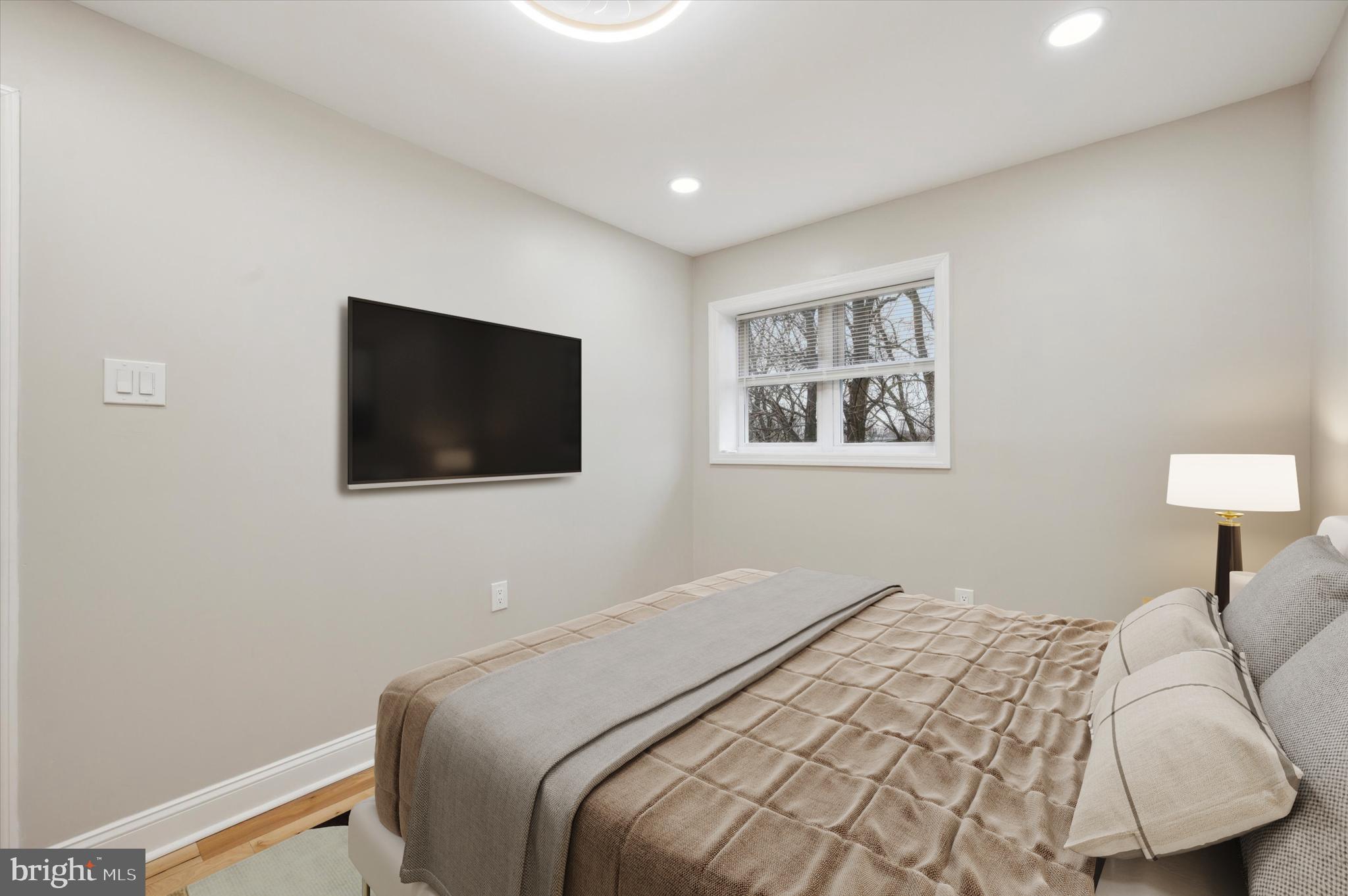 7533 Wheeler Street Philadelphia, PA 19153 - Photo 30 of 50 a bedroom with a bed and a flat screen tv