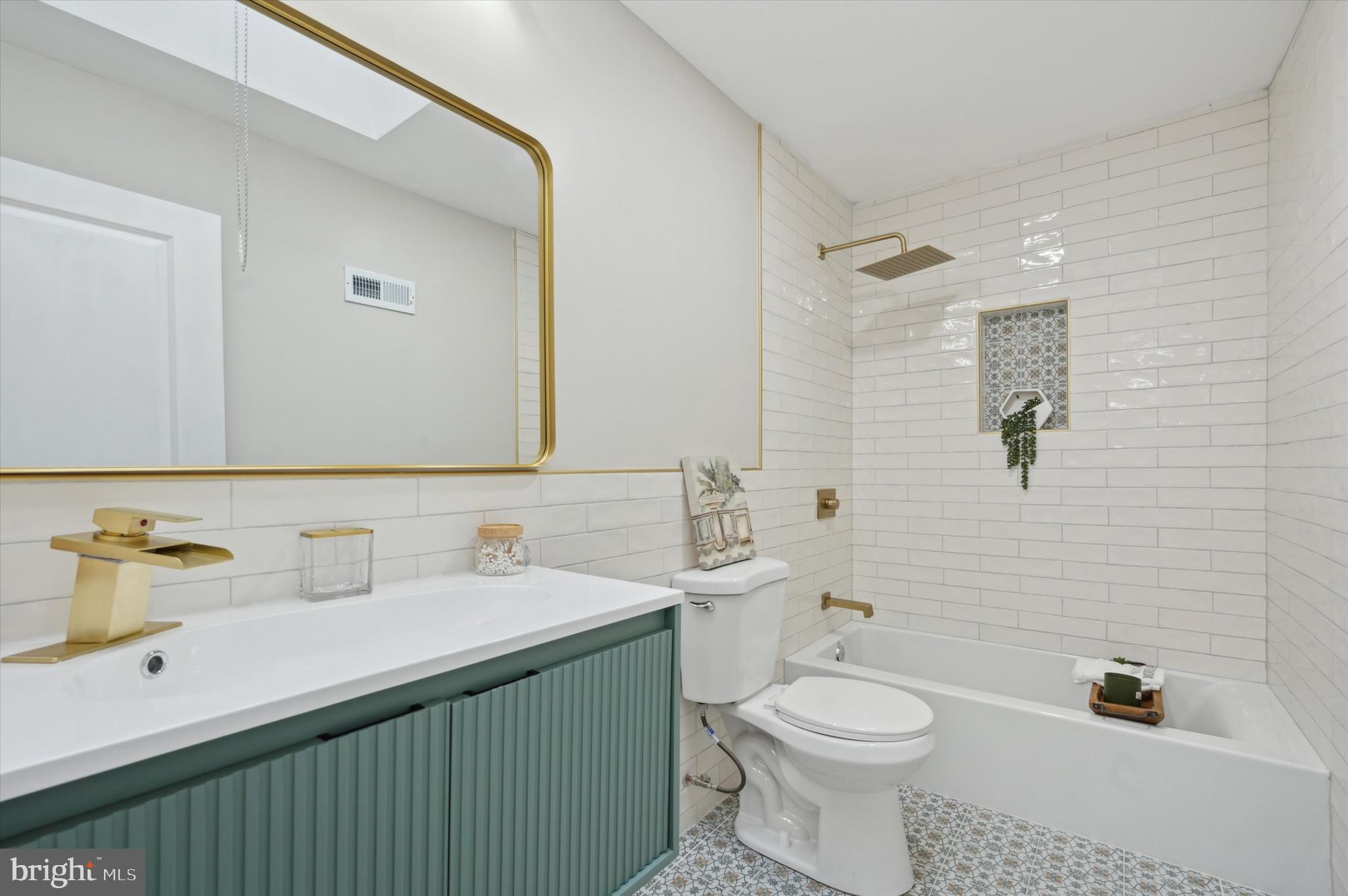 7533 Wheeler Street Philadelphia, PA 19153 - Photo 32 of 50 a bathroom with a sink a toilet and mirror