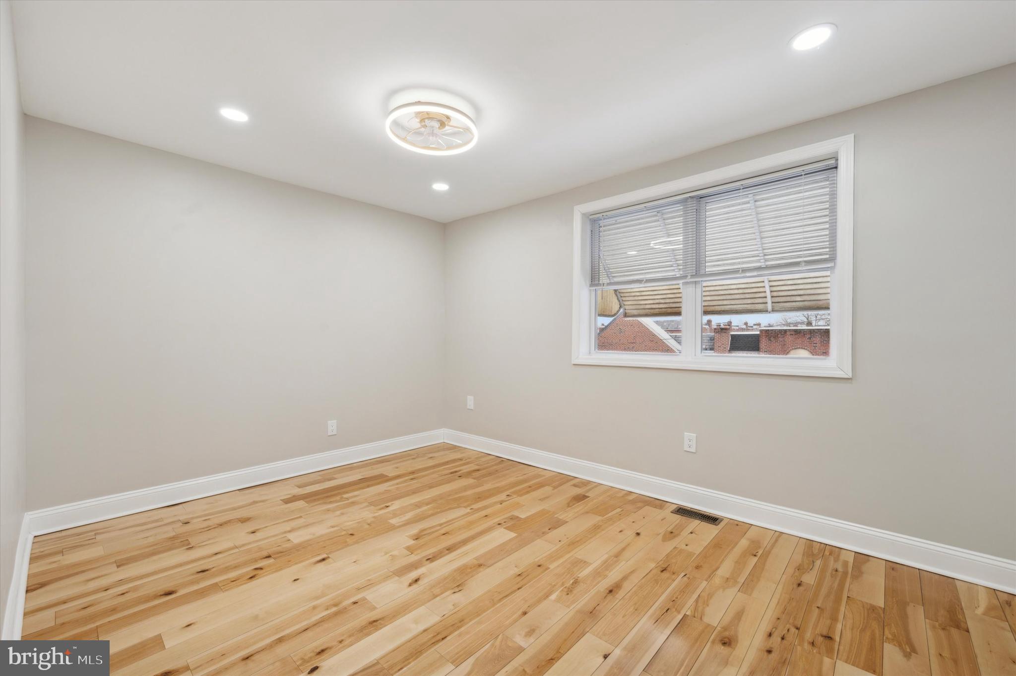 7533 Wheeler Street Philadelphia, PA 19153 - Photo 34 of 50 an empty room with wooden floor and windows