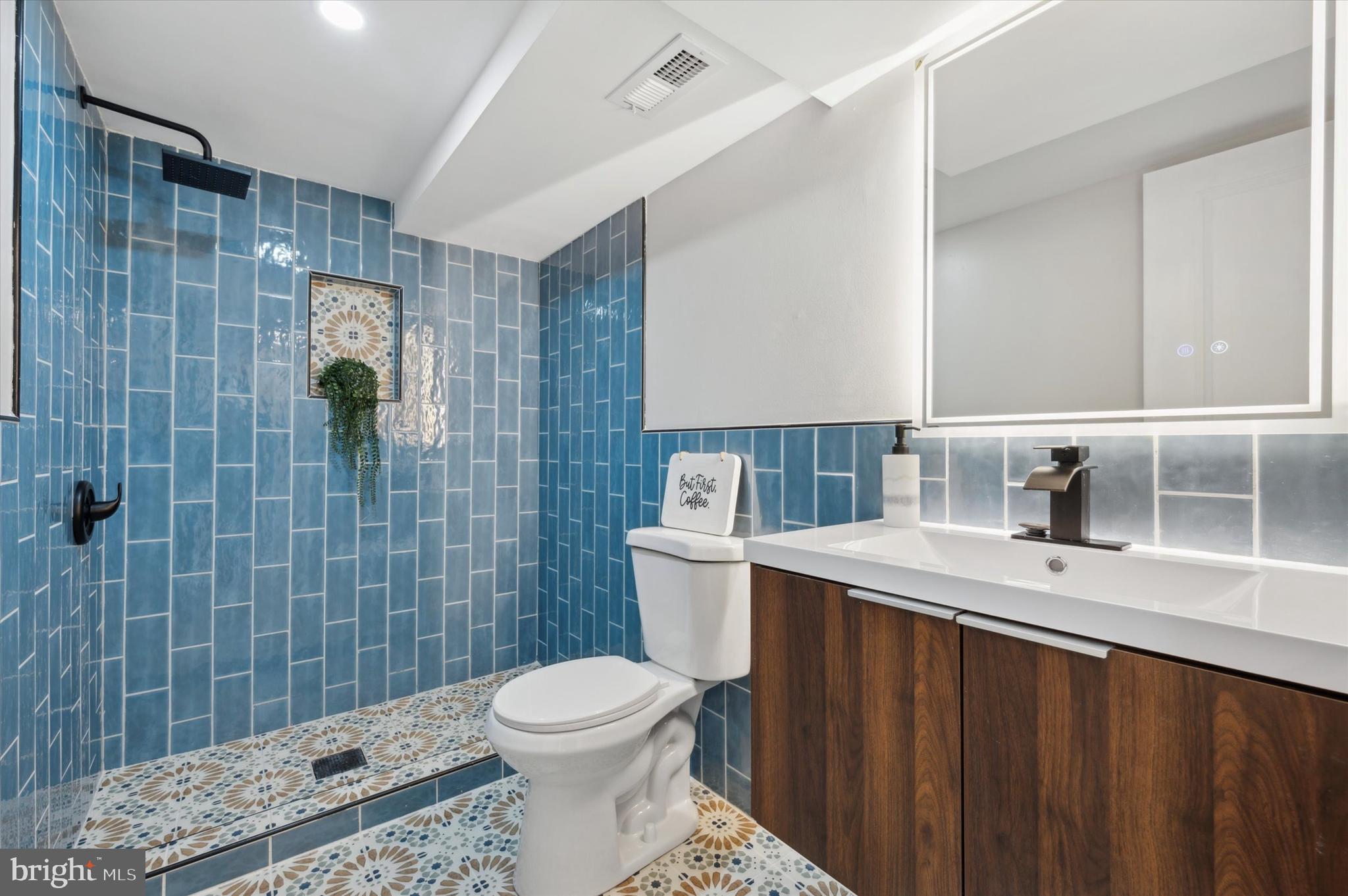 7533 Wheeler Street Philadelphia, PA 19153 - Photo 41 of 50 a bathroom with a sink a toilet and shower
