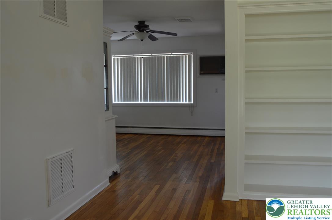 1819 Blue Barn Road Orefield, PA 18069 - Photo 10 of 21 Natural light illuminates rich hardwood floors, complemented by built-in shelving for storage.