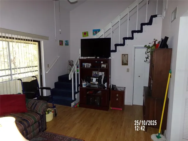 a front view of a house with a yard and palm trees
