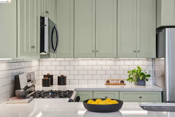 a kitchen with cabinets stainless steel appliances and a counter space