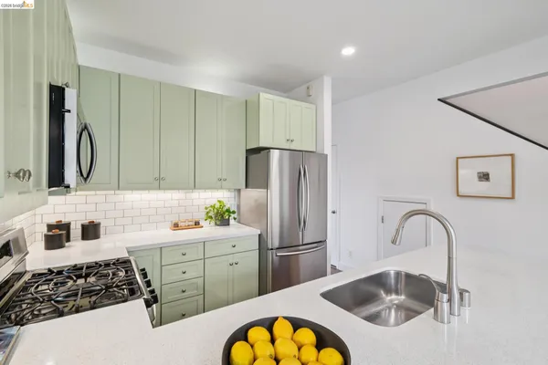 a view of a dining room with furniture a potted plant and wooden floor