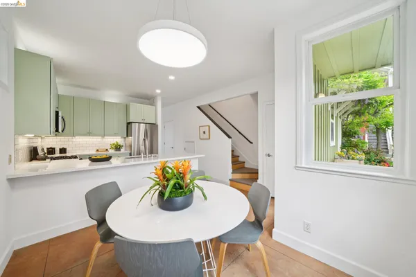 a dining room with furniture and wooden floor