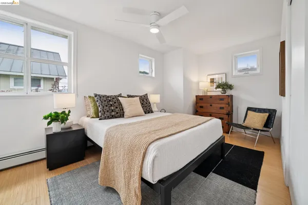 a spacious bedroom with a bed and a lamp