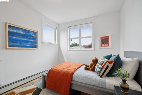 a bedroom with a bed and a painting on the wall