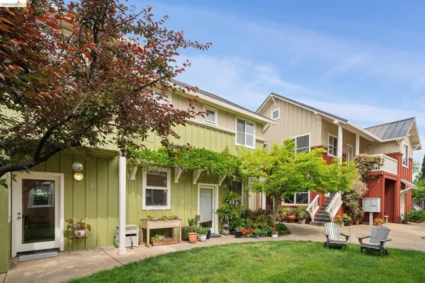 a view of a chair and table in the backyard