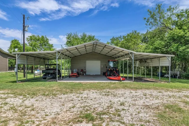 a view of a house with a yard and sitting area