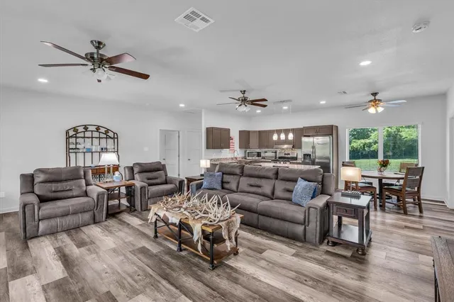 a living room with furniture and wooden floor