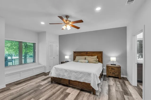 a bedroom with a large bed and a window