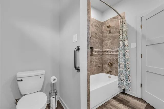 a bathroom with a toilet and a shower