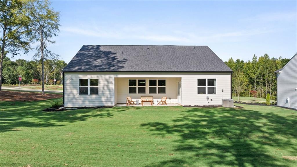 365 Bullock Pass Jefferson, GA 30549 - Photo 48 of 67 a front view of a house with a garden and trees