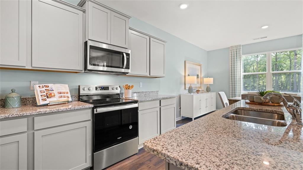 365 Bullock Pass Jefferson, GA 30549 - Photo 10 of 67 a kitchen with stainless steel appliances granite countertop a stove a sink and a microwave