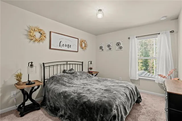 a bed sitting in a bedroom next to a window