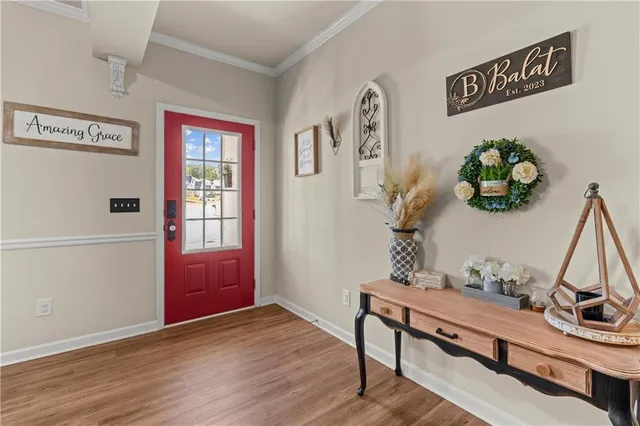a view of hallway with furniture and wooden floor