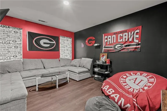 a living room with furniture and a wooden floor