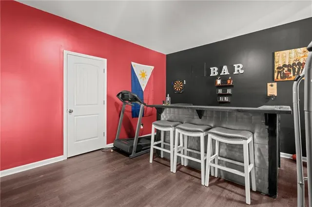 a view of a room with wooden floor and furniture