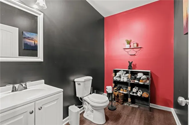 a bathroom with a toilet a sink and a mirror