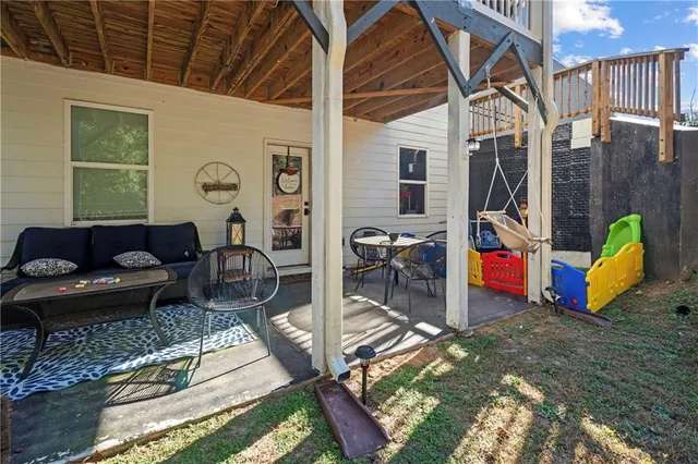a view of a balcony with chairs and wooden floor