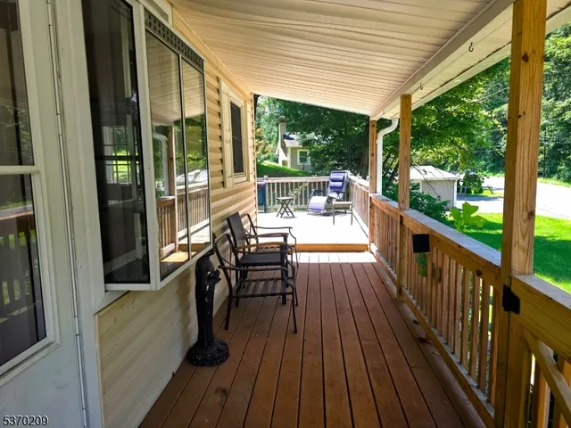 a view of balcony with chairs and wooden floor