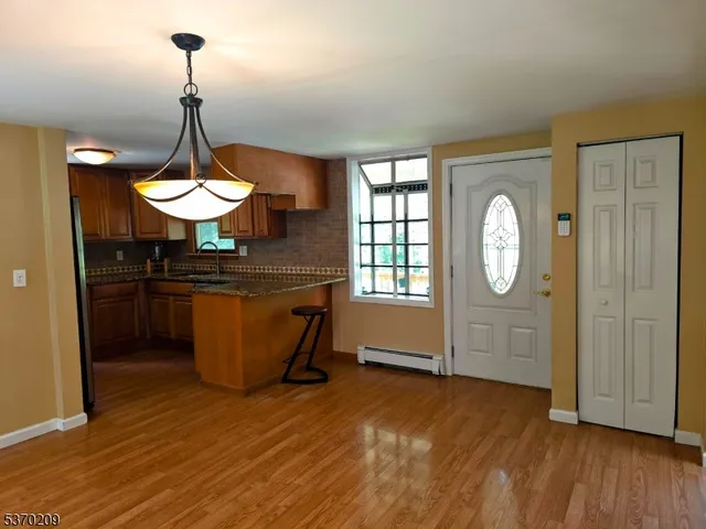 a kitchen with wooden floor and window