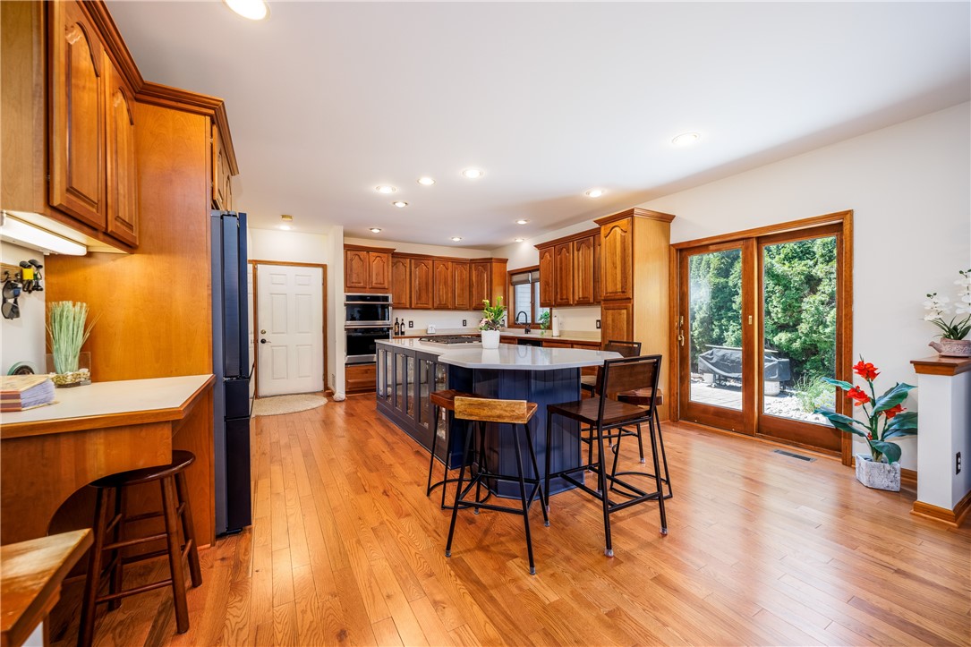 210 Buck Hill Road Greece, NY 14626 - Photo 12 of 49 COOK'S KITCHEN WITH BEAUTIFUL CABINETRY, ISLAND &