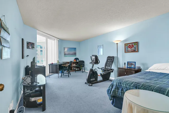 a view of a patio with a table and chairs under an umbrella