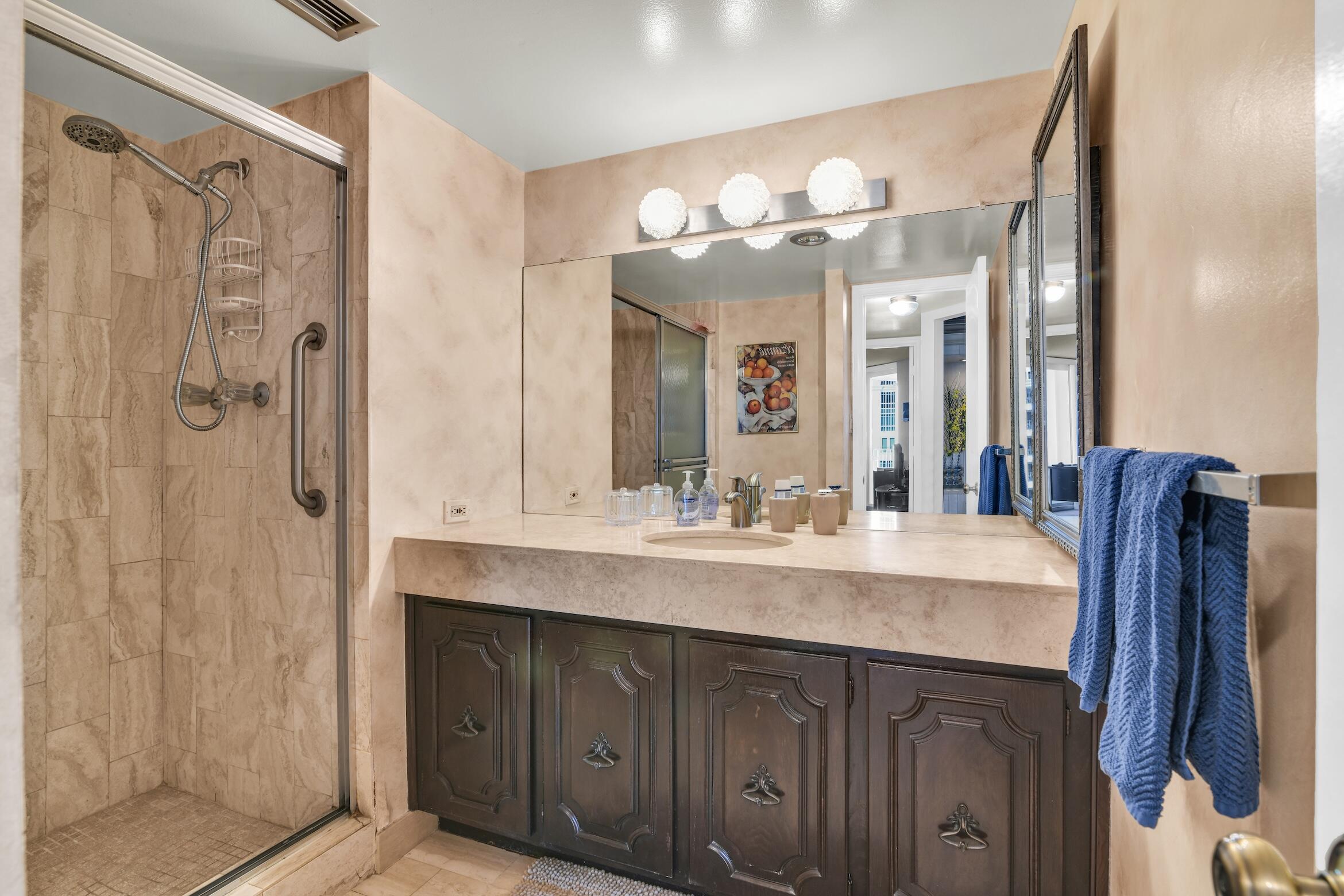 500 South Ocean Boulevard, Unit 803 Boca Raton, FL 33432 - Photo 19 of 72 a bathroom with a double vanity sink mirror and shower