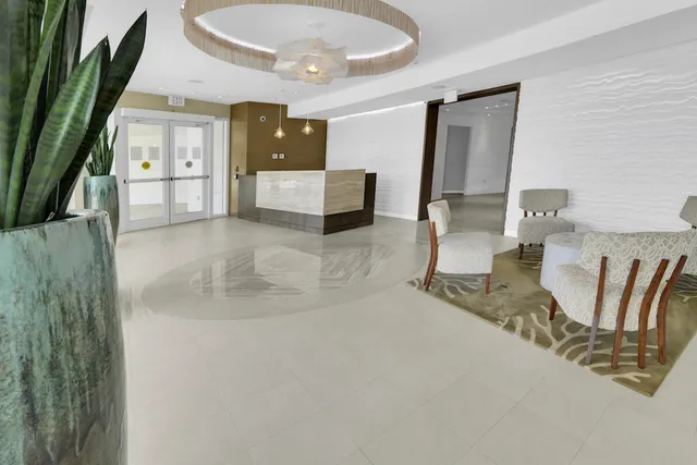 an aerial view of residential houses with outdoor space and swimming pool