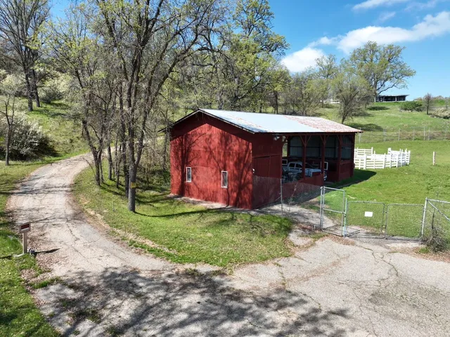 a view of a dry yard covered with snow in the background