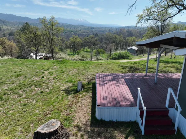 an aerial view of a house with swimming pool and a yard