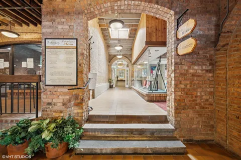 a hallway with a couple of furniture and a rug