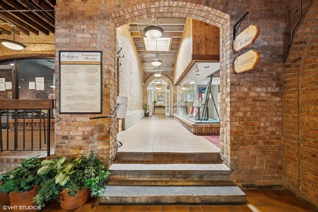 a hallway with a couple of furniture and a rug